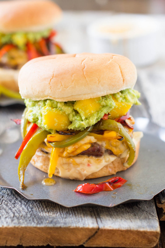 Over-the-top-burger-with-mango-guacamole-sauteed-peppers-sweet-chili-lime-mayo-and-melty-cheese-ohsweetbasil.com_-2-533x800